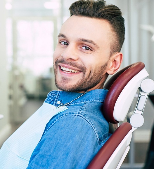 Man with veneers in Eugene smiling in treatment chair