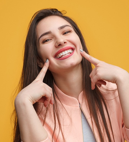 a woman smiling with dental bridges in Eugene