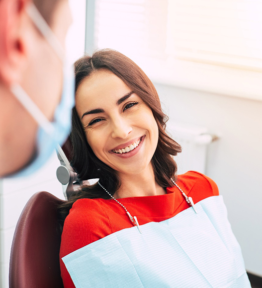 Happy patient at appointment to receive a dental crown