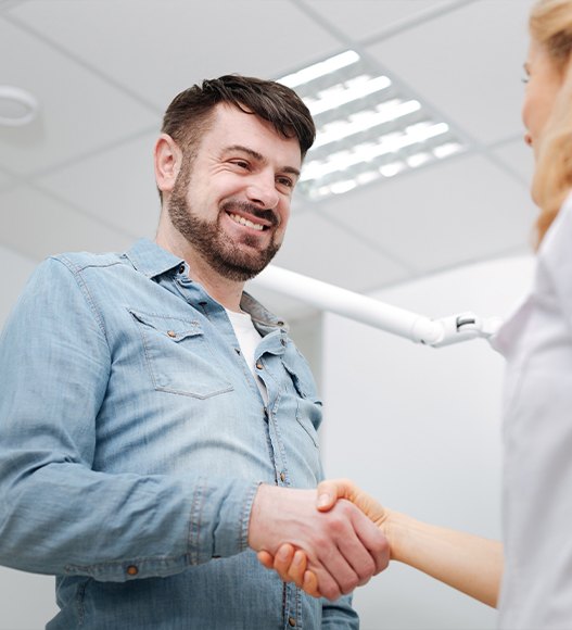 Man discussing dental insurance coverage for dental implant tooth replacement