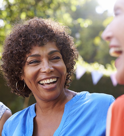 Woman with dental implant supported replacement tooth smiling