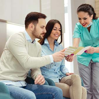 Young couple learning about options for paying for emergency treatment