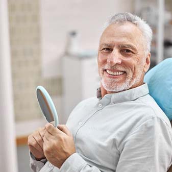 Happy senior dental patient at appointment for preventive care