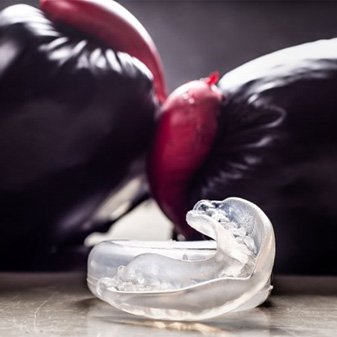 Pair of boxing gloves and mouthguard