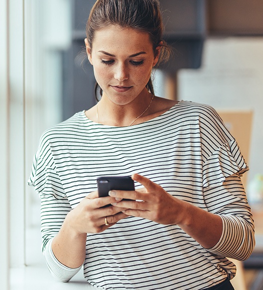 Woman using her smartphone to schedule an appointment