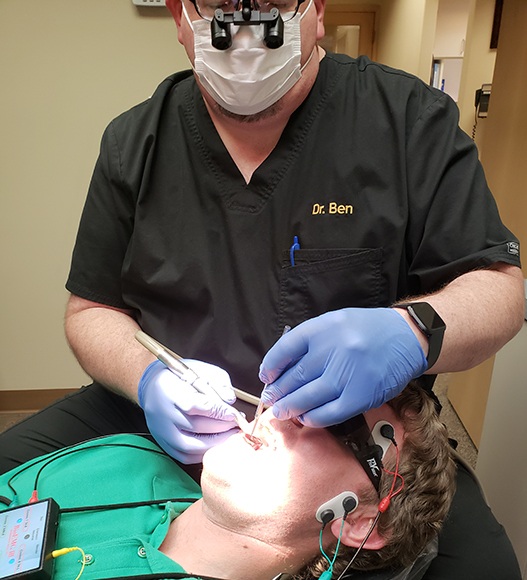 Dentist providing T M J treatment