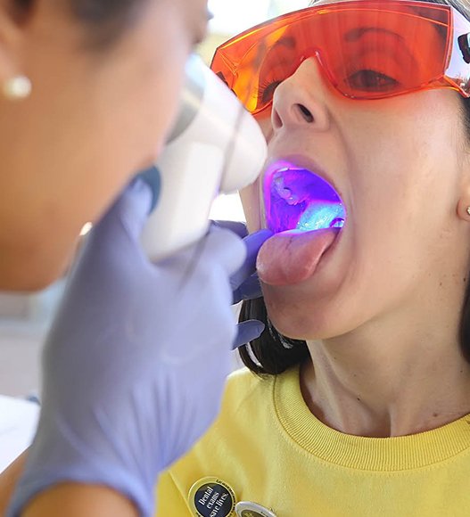 Woman receiving oral cancer screening