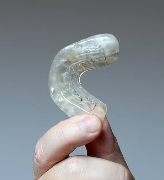 Hand holding a custom mouthguard