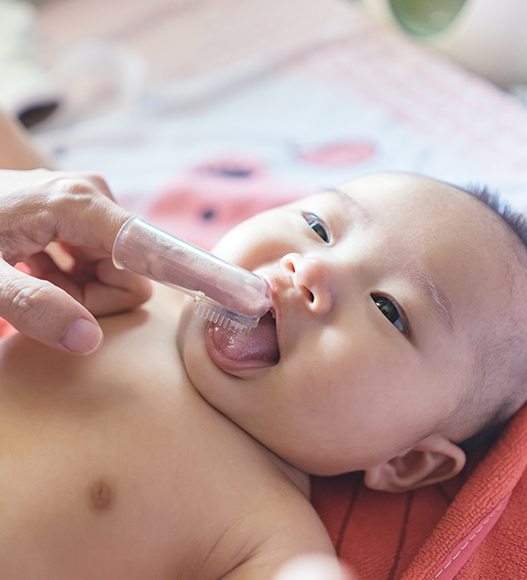 Dentist performing tongue and lip tie assessment