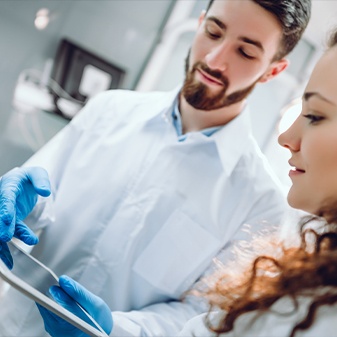 Dentist and patient discussing dental implant options