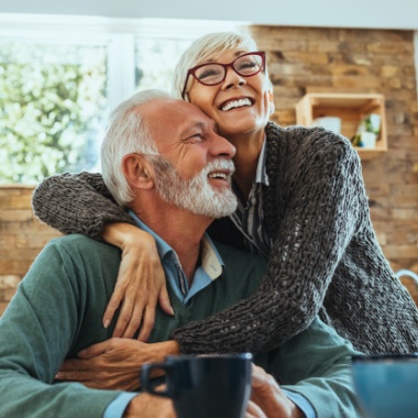 Man and woman with healthy smiles after restorative dentistry