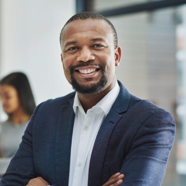 Man with complete smile after replacing missing teeth