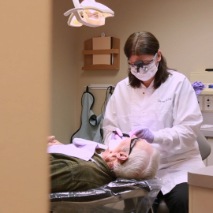 Dental team member examining dentistry patient