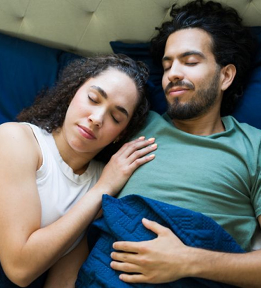 Couple sleeping peacefully in bed