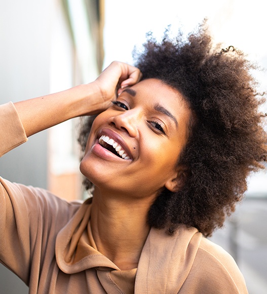 Woman with porcelain veneers sharing beautiful smile