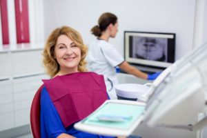 An older woman smiling with her same-day denture.