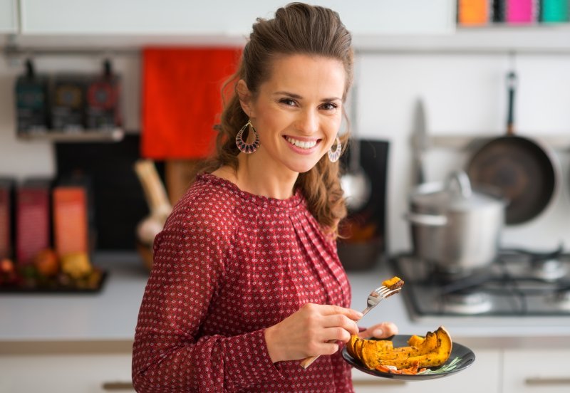 Smiling woman with Thanksgiving meal on plate