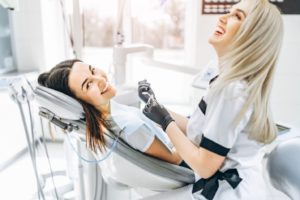 Patient and hygienist laughing during dental checkup