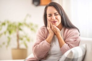 Grimacing woman suffering from a toothache